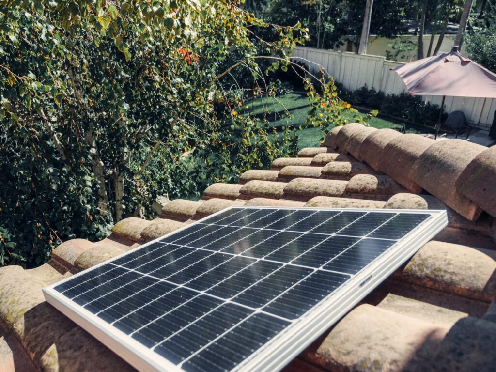 pexels-photo-9875439 Close-up of a solar panel installed on a tiled roof, capturing clean energy.